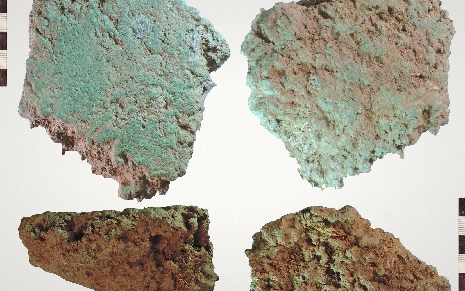 Four corroded copper-alloy ingot fragments with green and brown patina, shown front and back