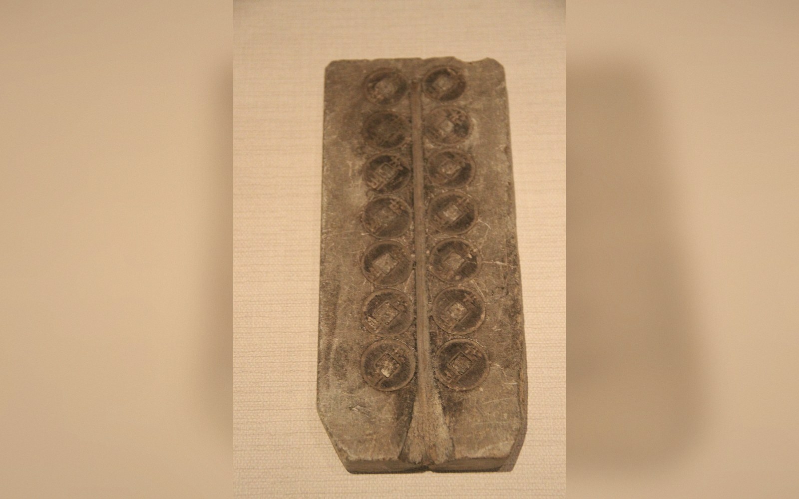 Two halves of a stone mould opened on a bench